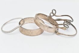 TWO SILVER BANGLES AND THREE WHITE METAL BANGLES, the first two hinged bangled with floral detail,