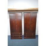A PAIR OF TALL STAG MINSTREL DOUBLE DOOR WARDROBES, each with two drawers, width 104cm x depth