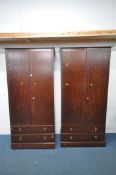 A PAIR OF TALL STAG MINSTREL DOUBLE DOOR WARDROBES, each with two drawers, width 104cm x depth