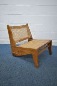 IN THE MANNER OF PIERRE JEANNERET FOR CHANDIGARH, A MID CENTURY KANGAROO CHAIR, with cane seat and