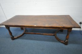 A REPRODUCTION SOLID OAK REFECTORY TABLE, on turned and block legs, united by a shaped Y