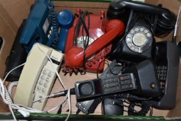 A BOX OF SEVEN VINTAGE TELEPHONES, comprising a black rotary dial phone with pull out draw,