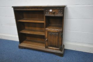 AN OLD CHARM OAK OPEN BOOKCASE, fitted with an arrangement of three shelves, a single drawer and