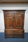 A 17TH CENTURY AND LATER OAK TWO DOOR CUPBOARD, the double fielded panel doors enclosing an open