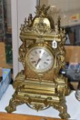 A LATE 19TH CENTURY FRENCH BRASS MANTEL CLOCK, with a dome top with a coronet finial, surrounded