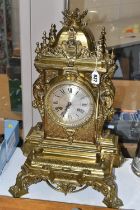 A LATE 19TH CENTURY FRENCH BRASS MANTEL CLOCK, with a dome top with a coronet finial, surrounded