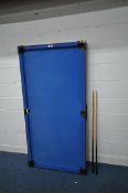 A POT BLACK POOL TABLE, with blue baize, folding legs, 184cm x depth 92cm, along with two queues (