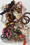 TWO BAGS OF COSTUME JEWELLERY, to include beaded necklaces, bangles, clip earrings, brooches etc