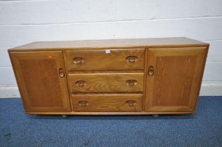 A MID CENTURY ELM ERCOL WINDSOR ROLLING SIDEBOARD, fitted with two cupboard doors, flanking three