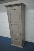 A PAINTED PINE CABINET, with a single door above two drawers, width 69cm x depth 58cm x height 194cm