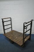 AN EARLY 2OTH CENTURY SLINGSBY SLIDING WHEEL PLATFORM TROLLEY, with beech slatted surface, wrought
