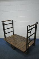 AN EARLY 2OTH CENTURY SLINGSBY SLIDING WHEEL PLATFORM TROLLEY, with beech slatted surface, wrought