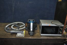 A HOOVER BREEZE VACUUM CLEANER with manual and some accessories along with a Sharp microwave (both