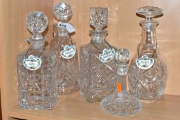 A GROUP OF FIVE EARLY 20TH CENTURY CUT CRYSTAL DECANTERS, together with four Crown Staffordshire