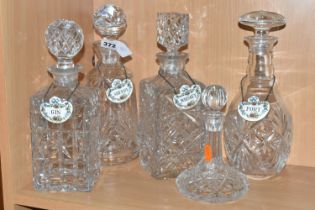 A GROUP OF FIVE EARLY 20TH CENTURY CUT CRYSTAL DECANTERS, together with four Crown Staffordshire