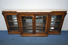 A VICTORIAN WALNUT MARBLE TOP BREAKFRONT BOOKCASE, the marble top splits into three sections, fitted