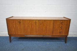 A MID CENTURY TEAK SIDEBOARD, fitted with three drawers, and three cupboard doors, on square tapered