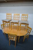 A MODERN BEECH DINING SUITE, comprising an oval extending dining table, with a single fold out leaf,