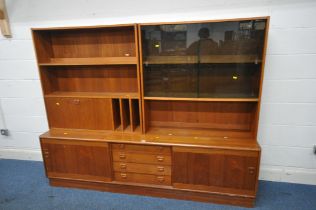 A MID CENTURY TEAK WALL UNIT, the two top sections fitted with an arrangement of glazed doors,
