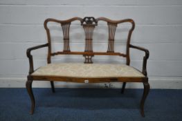 A VICTORIAN MAHOGANY SOFA, with wavy top and scrolled crest, three splat back supports, shaped