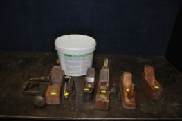 A TUB CONTAINING FIVE VINTAGE WOODEN PLANES, a brace and two hold downs