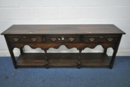 IN THE MANNER OF TITCHMARSH AND GOODWIN, A SOLID OAK DRESSER BASE, with three frieze drawers, a wavy