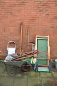 A WHEELBARROW, TWO DECK CHAIRS AND GARDEN TOOLS including a small step ladder, spades, forks,