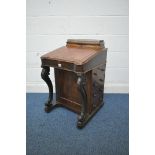 A VICTORIAN WALNUT DAVENPORT, the hinged pen tidy compartment with a gallery back, a red and