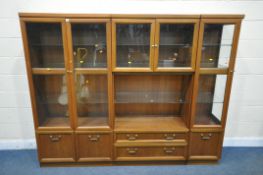 A MID CENTURY G PLAN TEAK WALL CABINET, comprising three sections, one section with double glazed
