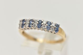 A GEM SET RING, a double row of round brilliant cut diamonds and round cut blue sapphire, prong