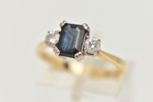 AN 18CT YELLOW GOLD SAPPHIRE AND DIAMOND THREE STONE RING, centring on a rectangular cut blue