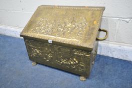 A 20TH CENTURY LOG BOX, the pressed brass depicting a variety of people, horses and buildings,