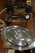 A VINTAGE BAKELITE AND WOOD TELEPHONE AND SILVERPLATE COVERED SERVING DISH, the phone handset is