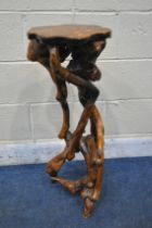 A ROOT WOOD PLANT STAND, the wavy hardwood top raised on a configuration of roots, height 80cm (