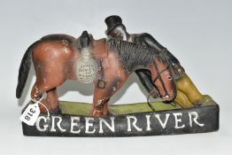 BREWERIANA: A GREEN RIVER BOURBON WHISKEY ADVERTISING FIGURE, of a man and horse, the saddle bag