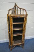 A BAMBOO CORNER CUPBOARD, with raised gallery back, oriental chinoiserie detail, the single door