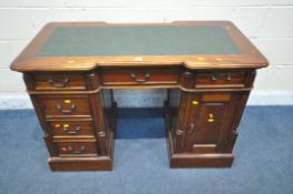 A 20TH CENTURY HARDWOOD DOUBLE REVERSE BREAKFRONT TWIN PEDESTAL DESK, with green leatherette writing