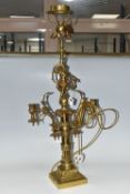 A LARGE BRASS FIGURAL TABLE LAMP, with three bulb fittings at the top, brass gimble and two flame