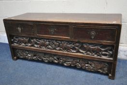 A 19TH CENTURY CHINESE HUANGHUALI LOW CABINET, fitted with three drawers, enclosing a further hidden