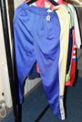 FOUR 1980S TRACK SUITS AND A LUTON FOOTBALL TOP, comprising a new and unused Adidas blue, white