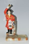 BREWERIANA: A CERAMIC BELL'S SCOTCH WHISKY ADVERTISING FIGURE 'AFORE YE GO', a Town Cryer ringing