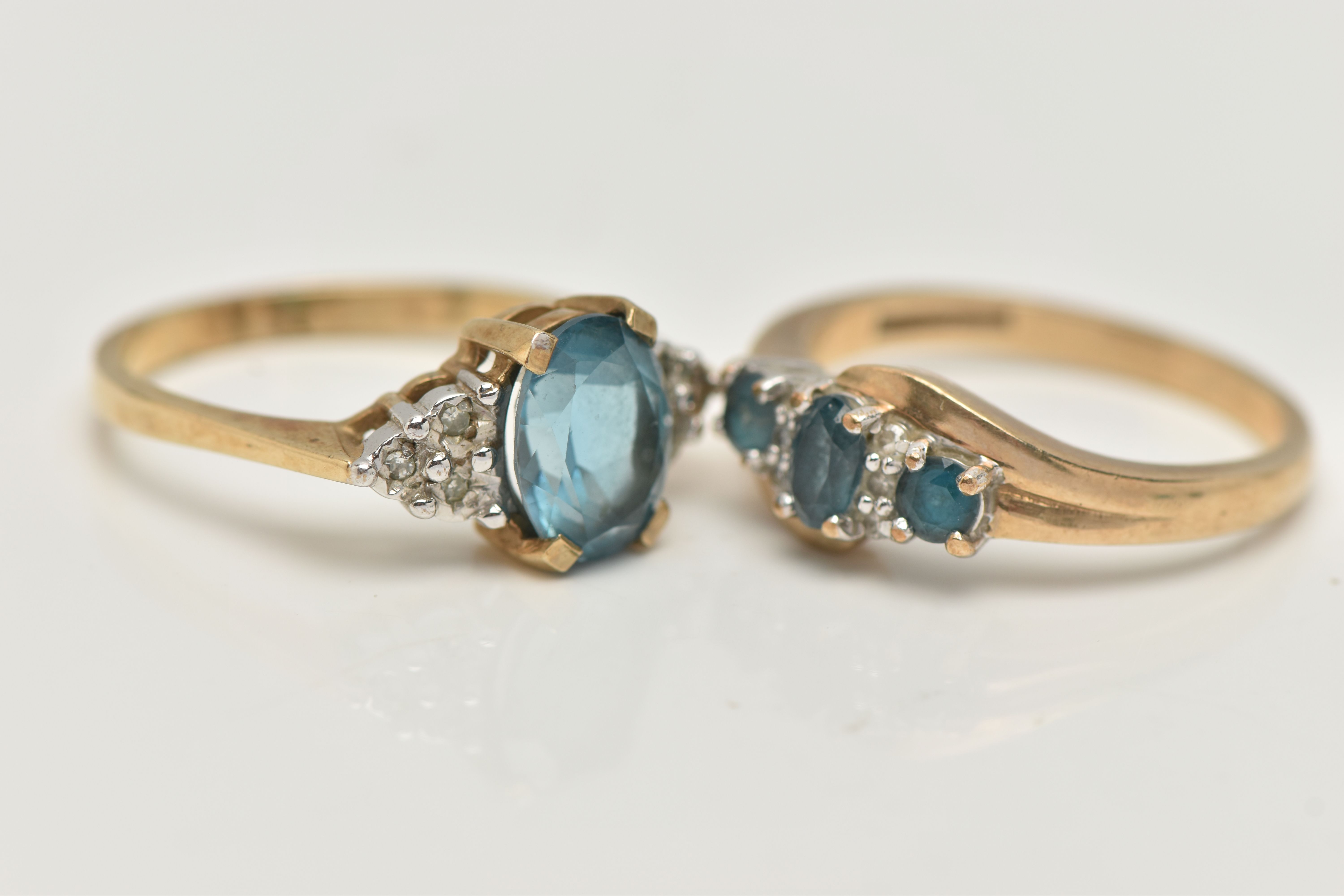 TWO 9CT GOLD GEM SET RINGS, the first an oval cut blue topaz, flanked with six single cut - Image 2 of 4