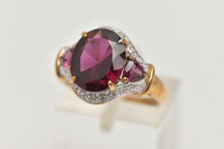 A 9CT GOLD GARNET AND DIAMOND DRESS RING, centring on an oval cut garnet, four claw set, flanked