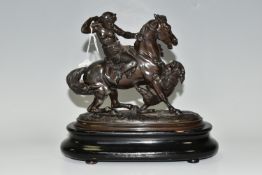 A BRONZED SPELTER FIGURE OF A YOUNG WOMAN ON HORSEBACK, defending herself from a tiger attack,