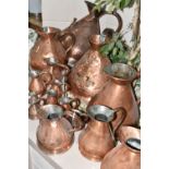 SIXTEEN COPPER JUGS, stamped with measurements, from 1/2 Gill to 5 Gallons, and weights and measures