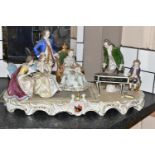 A SITZENDORF PORCELAIN FIGURE GROUP, depicting the six year old Mozart playing piano for a group