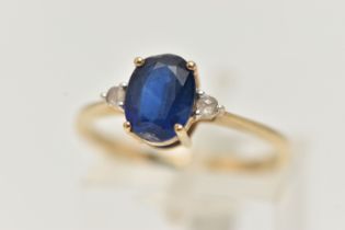 A 9CT GOLD SAPPHIRE AND DIAMOND RING, designed as a central oval sapphire flanked by rose cut
