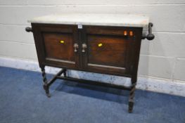 AN EARLY 2OTH CENTURY OAK MARBLE TOP WASH STAND, with twin towel rails, double doors, on barley
