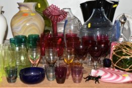 A GROUP OF COLOURED AND DECORATIVE GLASS WARES, to include a pink and white Nailsea bell and similar