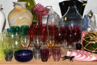 A GROUP OF COLOURED AND DECORATIVE GLASS WARES, to include a pink and white Nailsea bell and similar